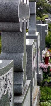 Close view along a row of granite monuments in a cemetery